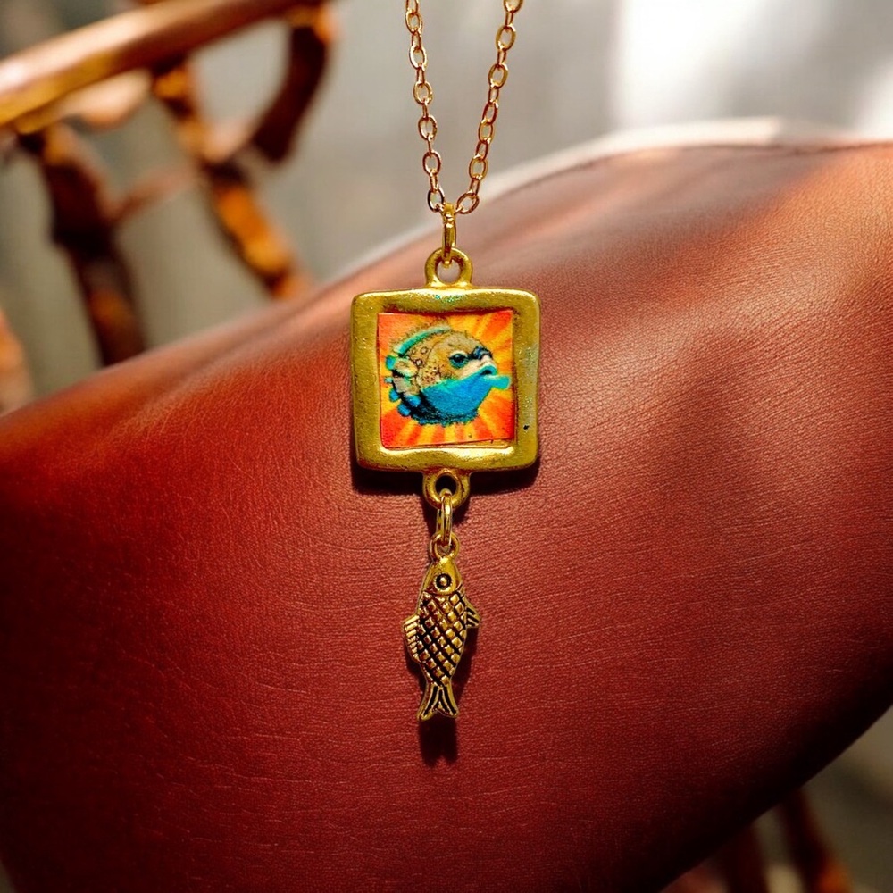 Handmade gold puffer fish pendant necklace with a dangling gold fish